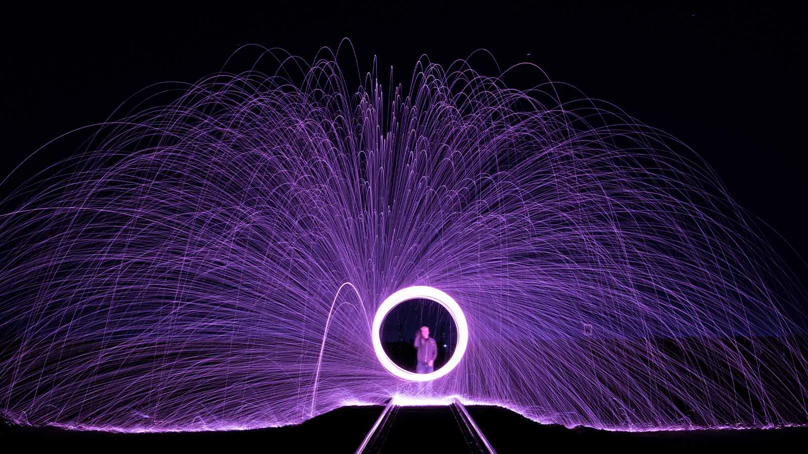Man standing in front of steel wool photography