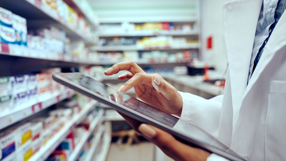 Pharmacist checking inventory in medical store