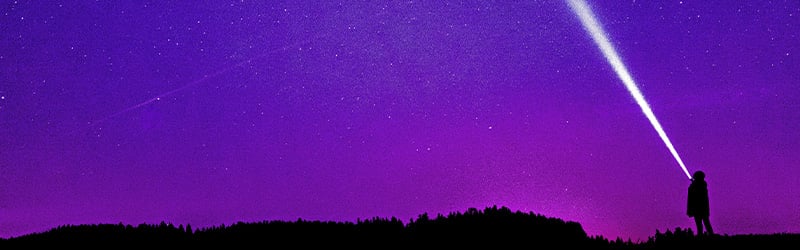 Silhouette of person under blue and purple sky